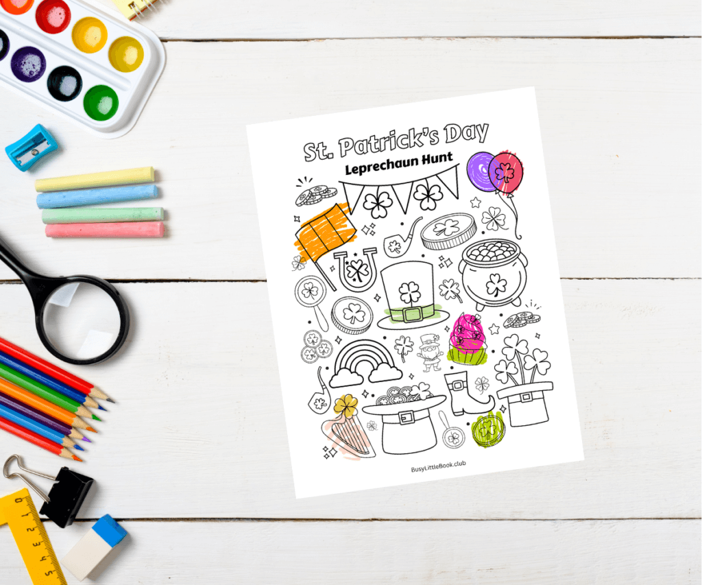 Kids desk with craft supplies next to a St. Patrick's Day themed coloring page and activity sheet