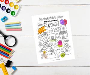 Kids desk with craft supplies next to a St. Patrick's Day themed coloring page and activity sheet